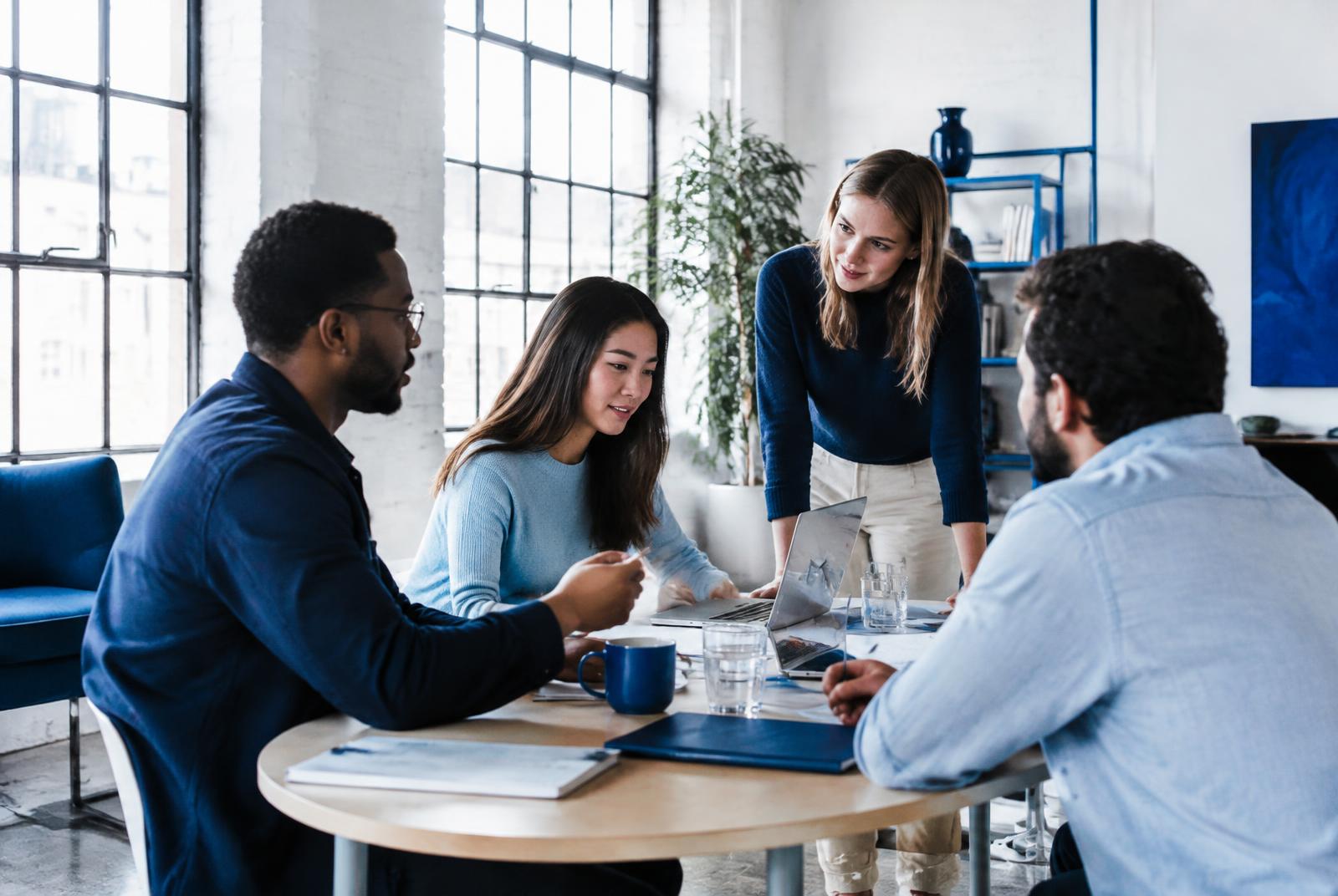 A small team collaborating in a bright creative office